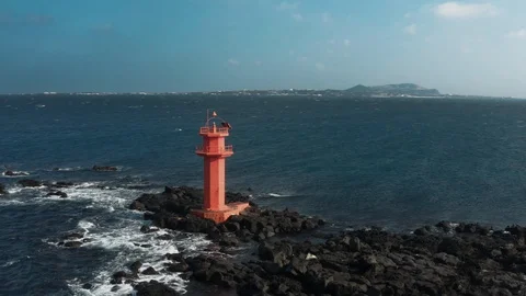 Aerial view. A lighthouse standing in the middle of the sea like an island. Dron Stock Footage 122271053