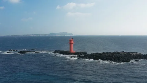 Aerial view. A lighthouse standing in the middle of the sea like an island. Dron Stock Footage 122272178