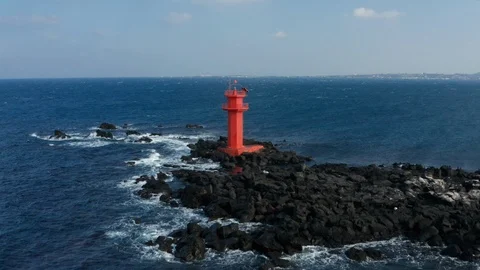 Aerial view. A lighthouse standing in the middle of the sea like an island. Stock Footage 122353448