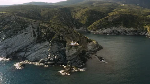 Aerial view on lighthouse staying on edge of rocky shore of Mediteraranean sea Stockbeeldmateriaal 139498901