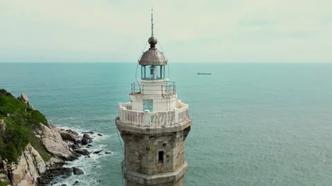 Aerial view of the lighthouse at sunset. Drone view of the sea lighthouse on the Stock Footage 231816529