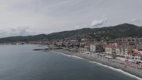 Aerial view of Ligurian town beachfront with umbrellas and promenade in summ Stock Footage 316632503