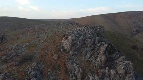 Aerial view of limestone cliff face and rolling mountain slopes in Kazakhstan Stock Footage 337455071