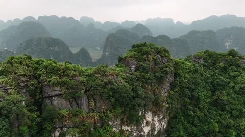 Aerial view of limestone karst peaks covered in lush jungle in ninh binh pr.. Video stock 335081161
