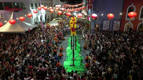 Aerial view Lion dance performance on high pole in front of visitors Видео 234077499