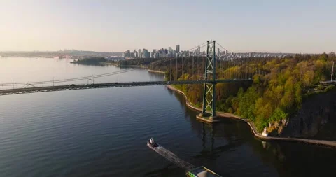 Aerial view of Lions Gate Bridge and Stanley Park at dawn. Canada Stock Footage 240890367