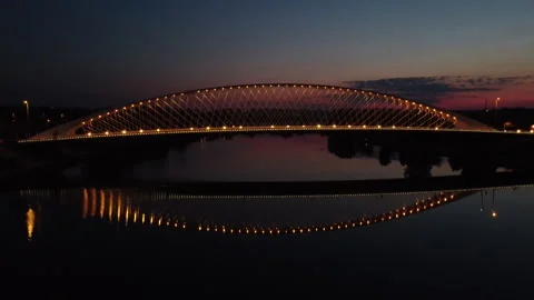 Aerial view of the lit-up Troja Bridge after sunset Stock Footage 161109716