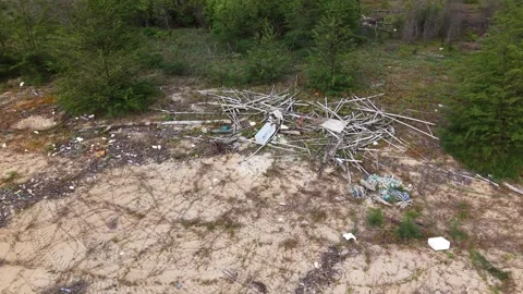 Aerial view of littered sandy area with tangled branches and waste Stock Footage 332596285