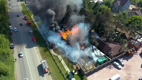Aerial view of a live fire training exercise with a fully involved house. 4K Stock Footage 113111844