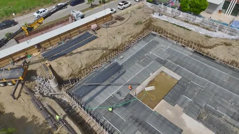 Aerial View: A lively construction site features insulation work and metal Stock Footage 296097428