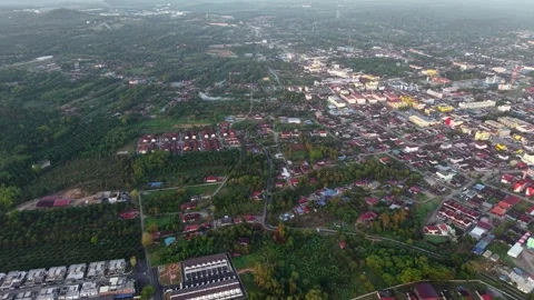Aerial view of a lively town surrounded by greenery Vídeo Stock 332600516