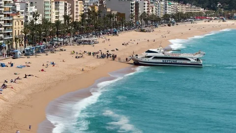Aerial view of "LLoret de Mar", When a tourist boat arrives at the beach. Video stock 89221365
