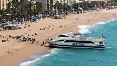 Aerial view of "LLoret de Mar", When a tourist boat arrives at the beach. Stock Footage 89223858