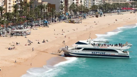 Aerial view of "LLoret de Mar", When a tourist boat arrives at the beach. Stock Footage 89224259