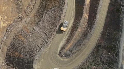 Aerial view of a loaded dump truck driving in a quarry Видео 343845273