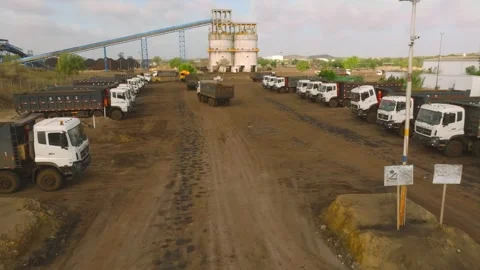 Aerial view of loaded dump trucks leaving the Thar coal mining facility in Stock Footage 337908016