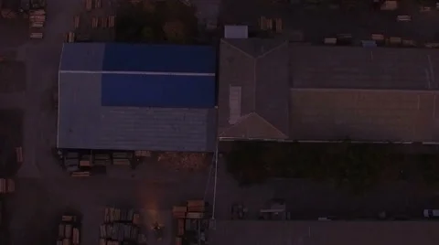 Aerial view of loaders transporting wood packages at night in warehouse Stock Footage 61828751