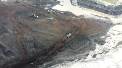Aerial view of loading and unloading activities of coal transport trucks in.. Stock Footage 321341436