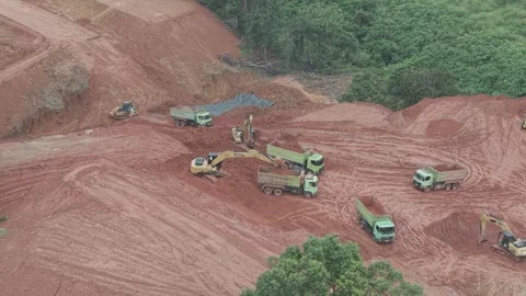 Aerial view of loading and unloading activities of trucks and excavators fo.. Stock Footage 334921908