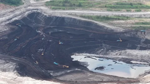 Aerial view of loading and unloading activities at a coal mine Stock Footage 337810089