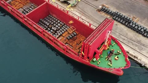 Aerial view of loading ship. Port crane loads metal, steel coils into dry cargo Stock Footage 281362508