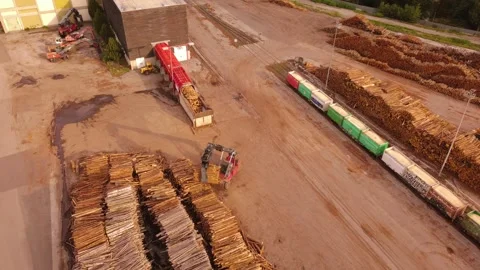 Aerial view of a log yard with a log stacker and freight wagons, Austria 動画素材 344735173