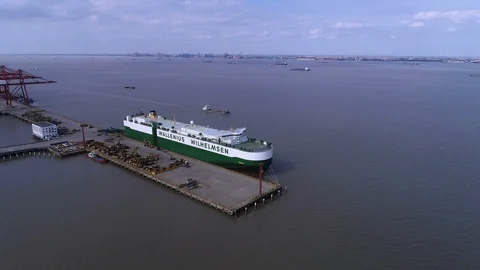 Aerial view of logistics concept floating dry dock servicing cargo ship and c Stock Footage 97335110