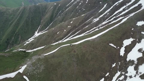 Aerial view of a lone mountain hut on a ridge Stock Footage 345386572