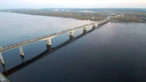 Aerial view of a long bridge over a wide river, active traffic on the bridge. Stock Footage 116495737