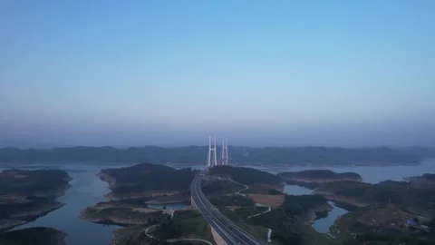 Aerial view of a long cable stayed bridge crossing a large calm reservoir Video stock 342324785