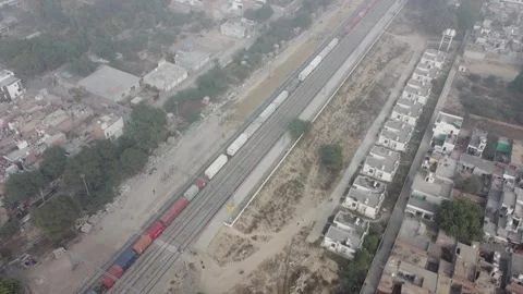 Aerial view of a long cargo train moving through city outskirts 스톡 동영상 335270967