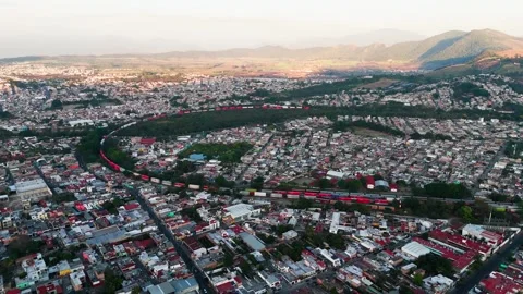 Aerial view of long freight train crossing tepic, mexico Stock Footage 332132249