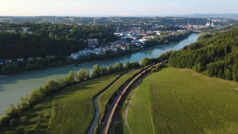 Aerial view of a long freight train travelling along the river Inn toward Passau Vídeo Stock 341466601