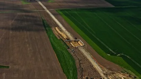 Aerial View of Long Infrastructure Construction Trench Through Agricultural Stock-Fotos