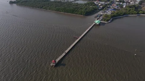 Aerial view of a long pier extending over the sea Stock Footage 329732641