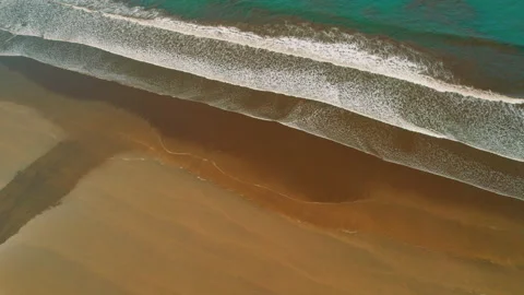 Aerial view of long rolling ocean waves on dark sand in Costa Rica Stock Footage 341448586