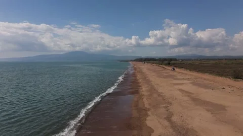 Aerial View of Long Sandy Beach, Calm Sea and Mountains in Greece Stock-Footage 330968069