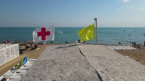Aerial view of the long sandy Bugaz Spit, and visible flags marking lifeguard  Video stock 312861992