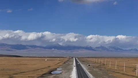 Aerial view of long straight road across open desert plateau in Xinjiang China Stock Footage 337887986