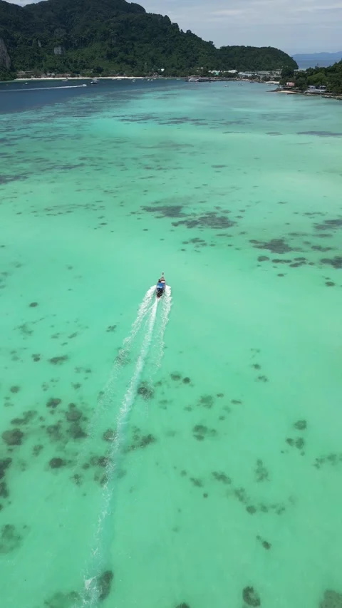 Aerial View of Long Tail Boat Cruising in Tropical Turquoise Sea in Koh Phi Phi, Stock Footage 334723102