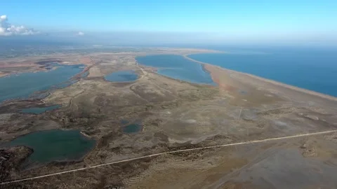 Aerial view of long thin sand tombolo separating - Sea Calm and Coastal Ecology Stock Footage 339391985