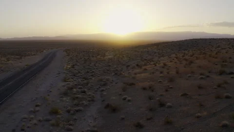 An aerial view of a long winding road at sunset. Stock Footage 155707331