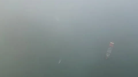 Aerial view look down misty cloud cover container ship Video stock 255420704
