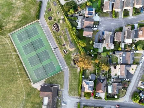 Aerial view looking directly down on tennis courts and a children's play area at Stock Photos