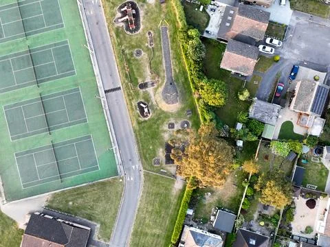 Aerial view looking directly down on tennis courts and a children's play area at Stock Photos
