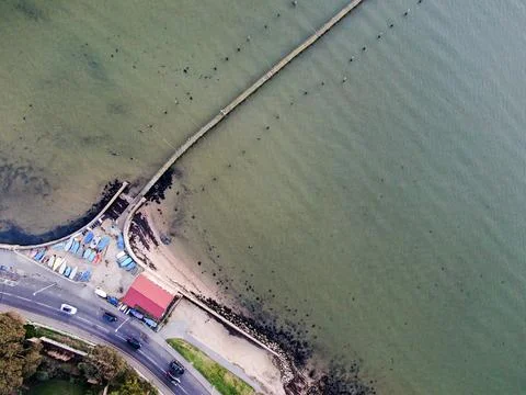 An aerial view looking directly down onto a small boat yard with jetty next to a Stock Photos