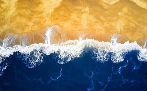 Aerial View looking down on a Beach. Deep Blue waves and beach Stock Photos