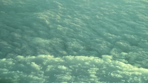 AERIAL VIEW: Looking down at a dense blanket of clouds from an airplane Stock Footage 343863911