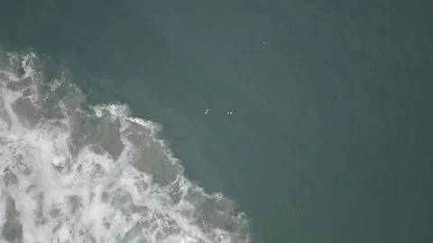 Aerial View Looking Down at Ocean Waves Crashing Along the Coastline Stock Footage 246408899