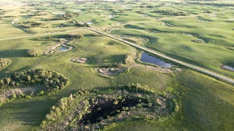 Aerial view looking down onto a prairie agricultural landscape of farmland that  Stock Footage 278683176